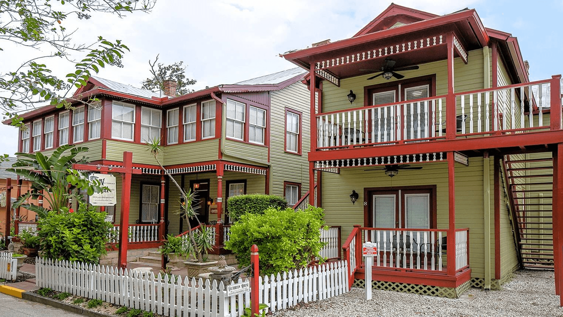 exterior of inn, double buildings, exterior stairs painted green with accent
